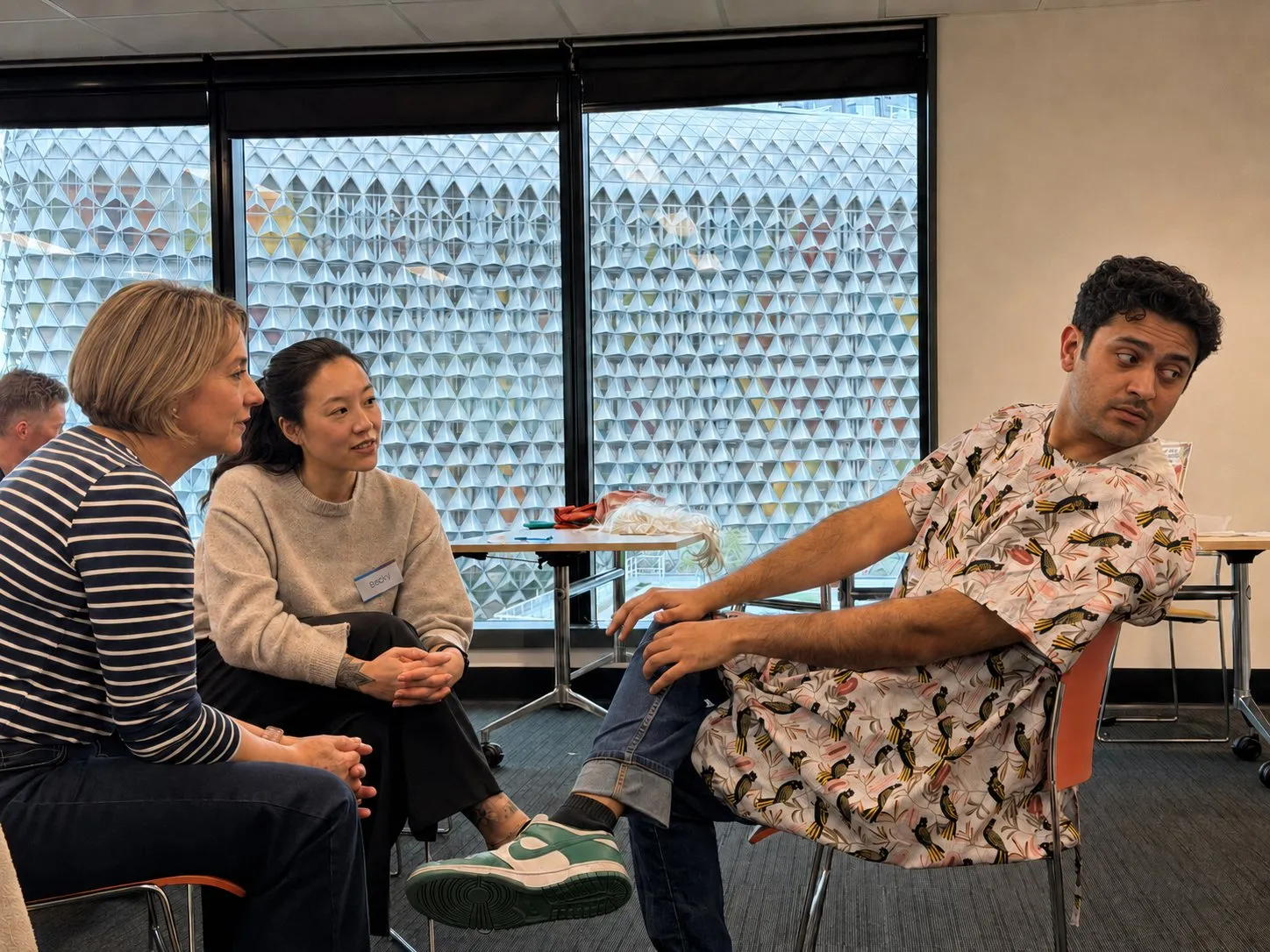 Participants seated in a circle in a training room during a workshop discussion